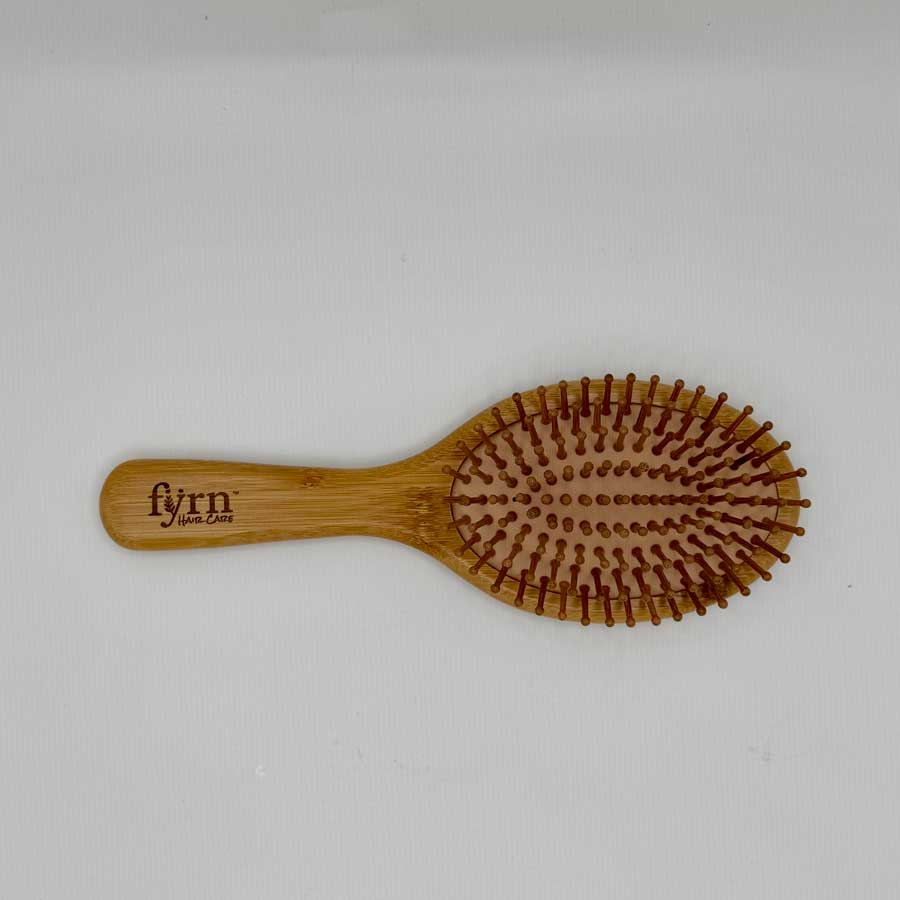 Wooden hairbrush with bristles on a white background