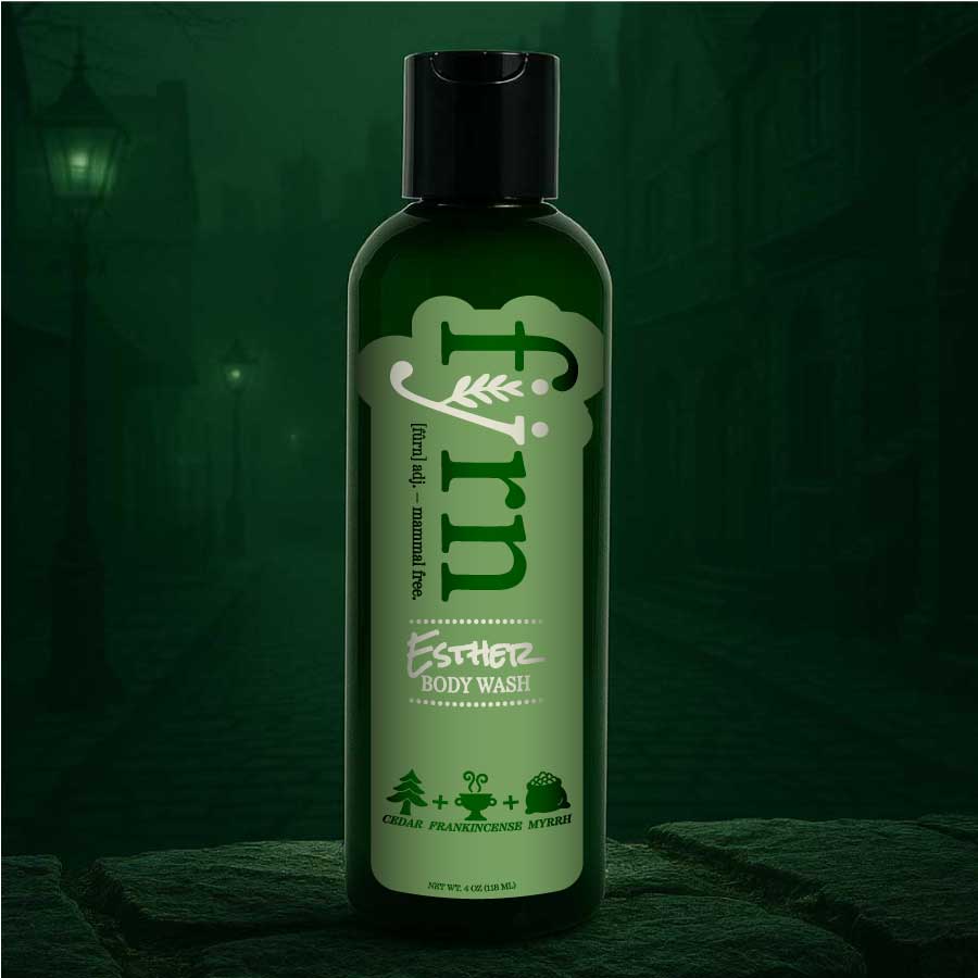 Green bottle of body wash with a dark green background
