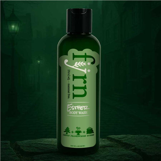 Green bottle of body wash with a dark green background