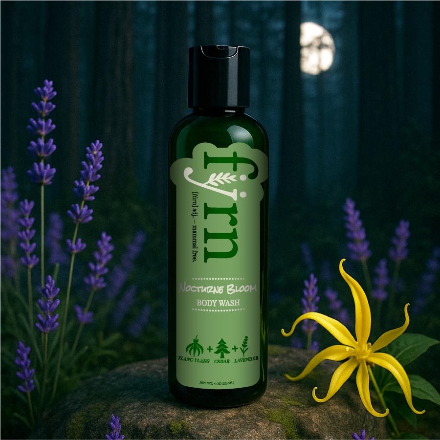 Bottle of 'Firn' body wash with lavender and a yellow flower in a forest setting