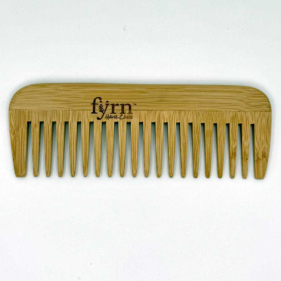 Wooden comb with 'fyrn' branding on a white background