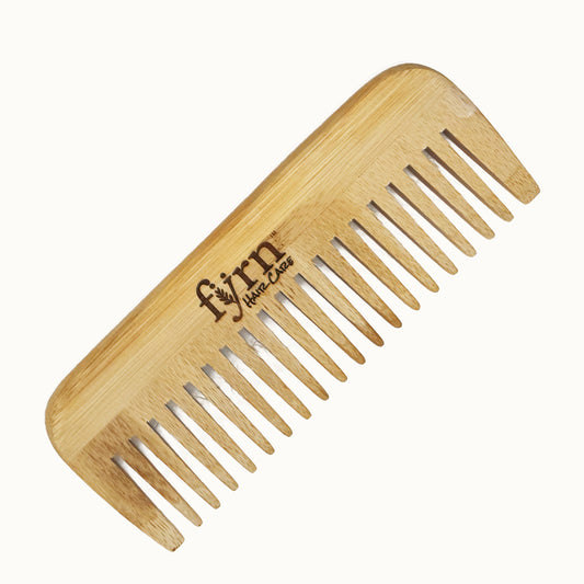 Wooden comb with 'fyrn' branding on a white background