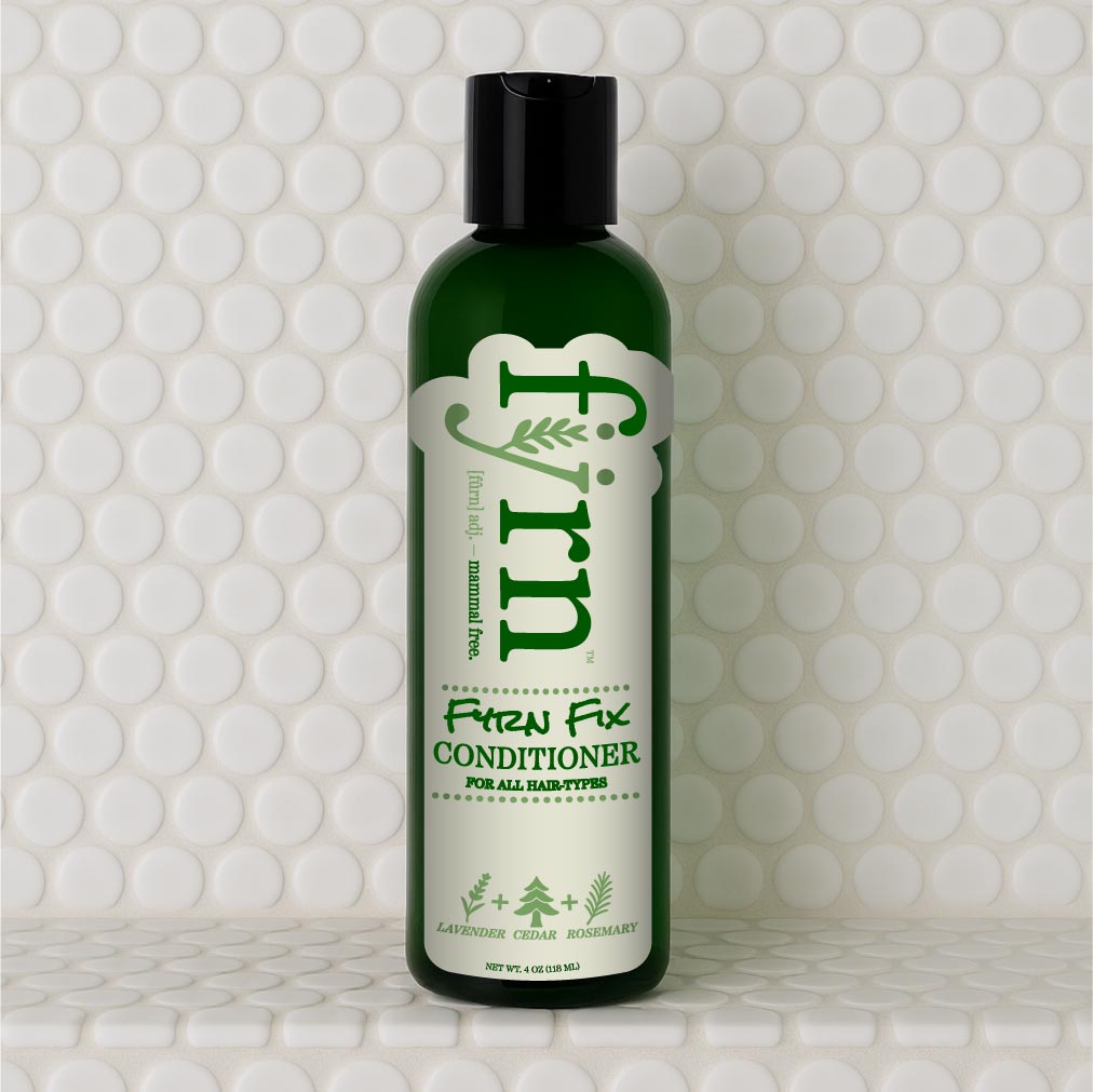 Green bottle of 'Fyrn' Fix Conditioner on a white tiled background