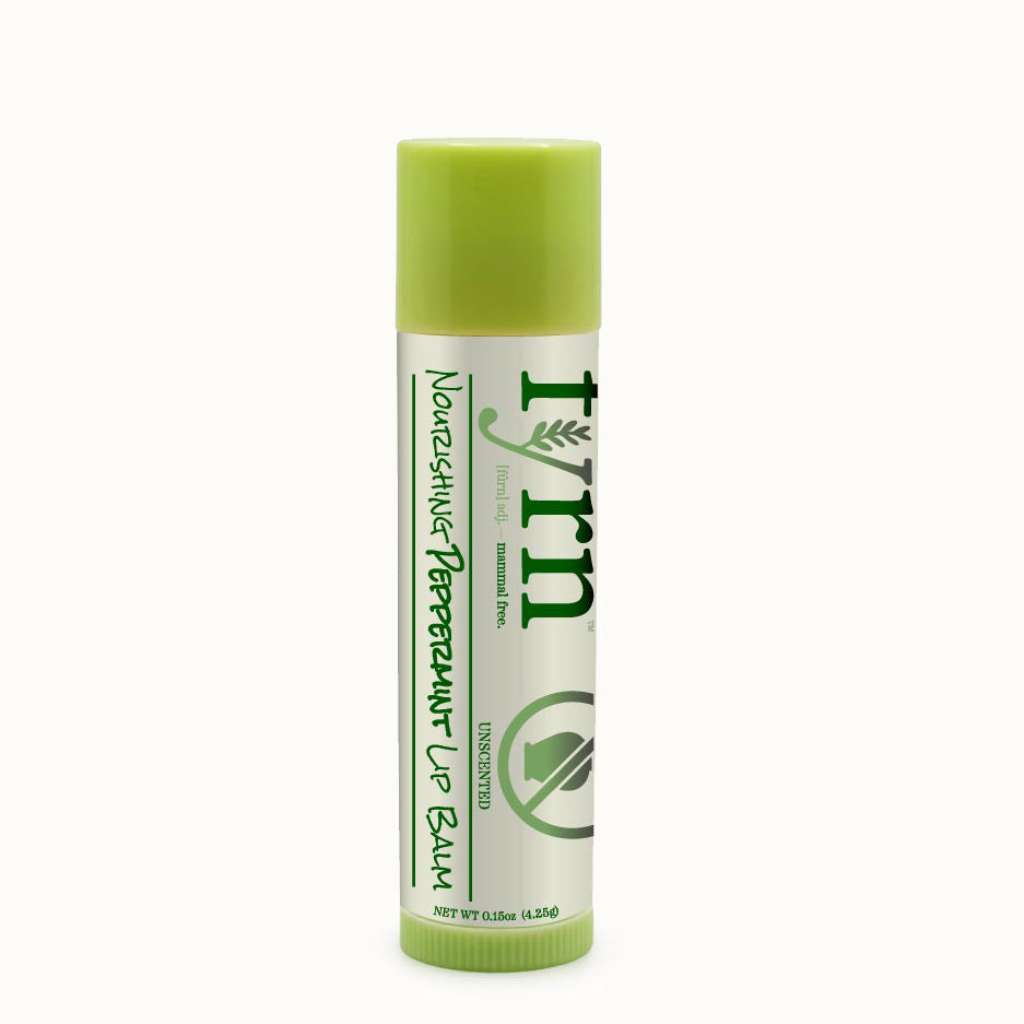 Lip balm with green cap and label on a white background