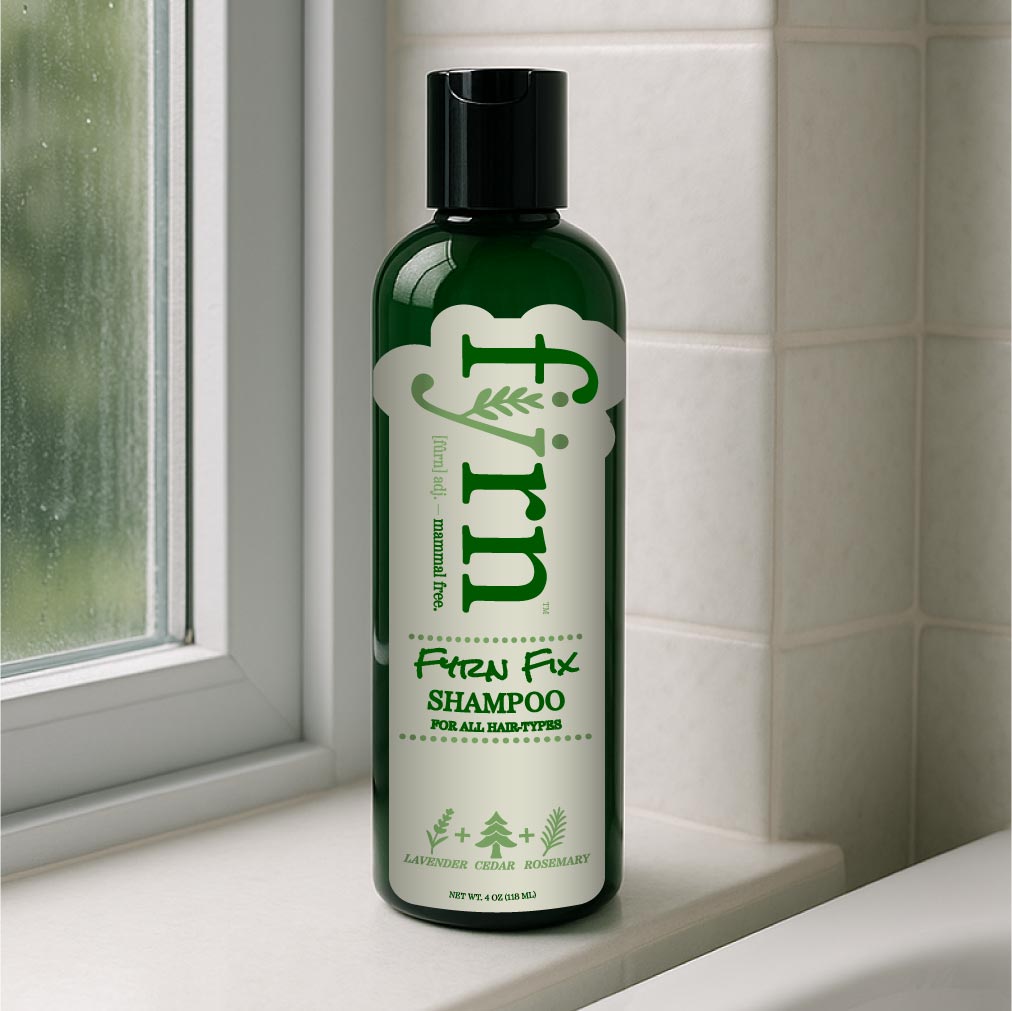 Green shampoo bottle labeled 'Fyrn' on a bathroom shelf.