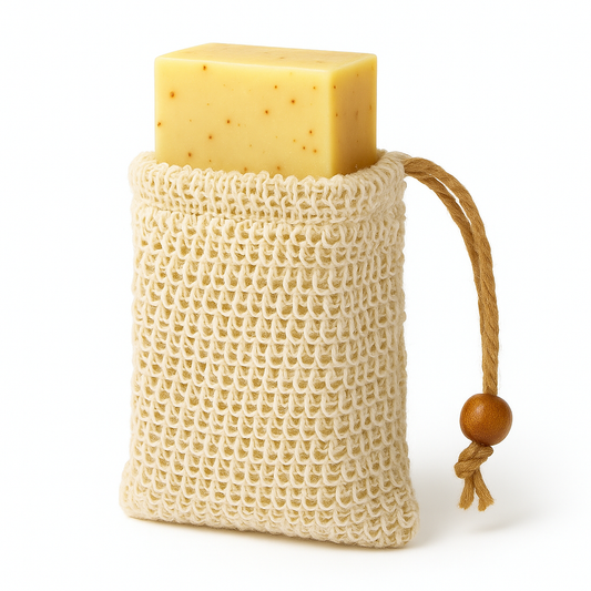 Bar of soap in a natural fiber bag with a wooden handle on a white background