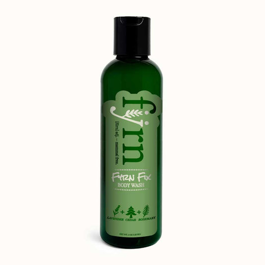 Green bottle of Fyrn™ Fix body wash on a white background