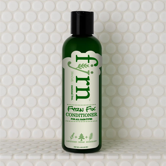 Green bottle of 'Fyrn' Fix Conditioner on a white tiled background